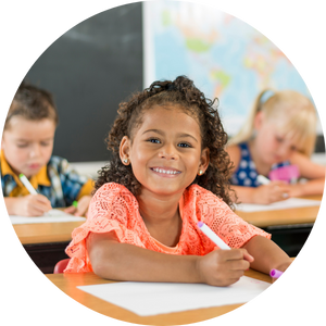 elementary students working in class with markers